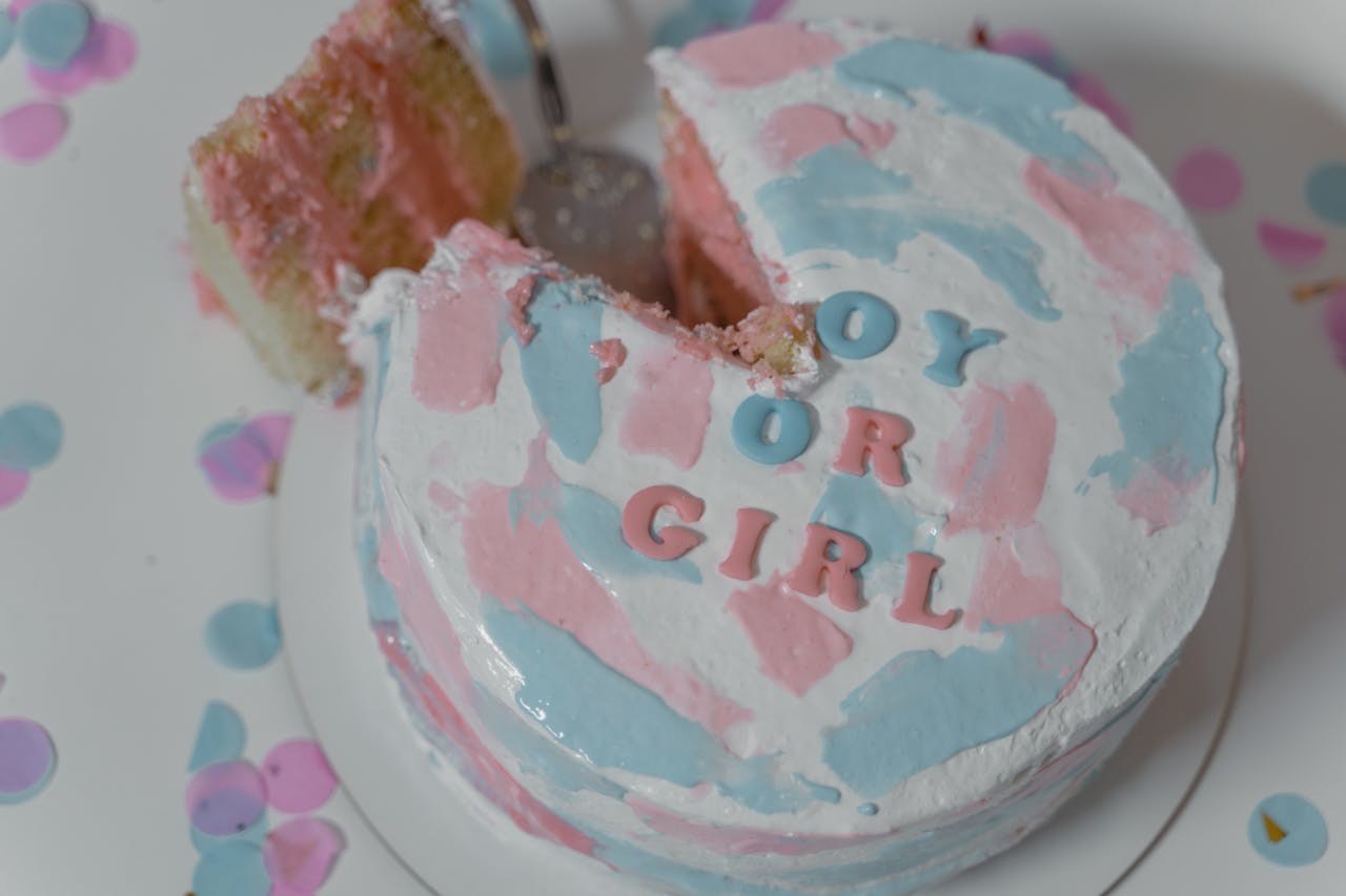 Festive gender reveal cake with pink and blue icing for a special celebration.